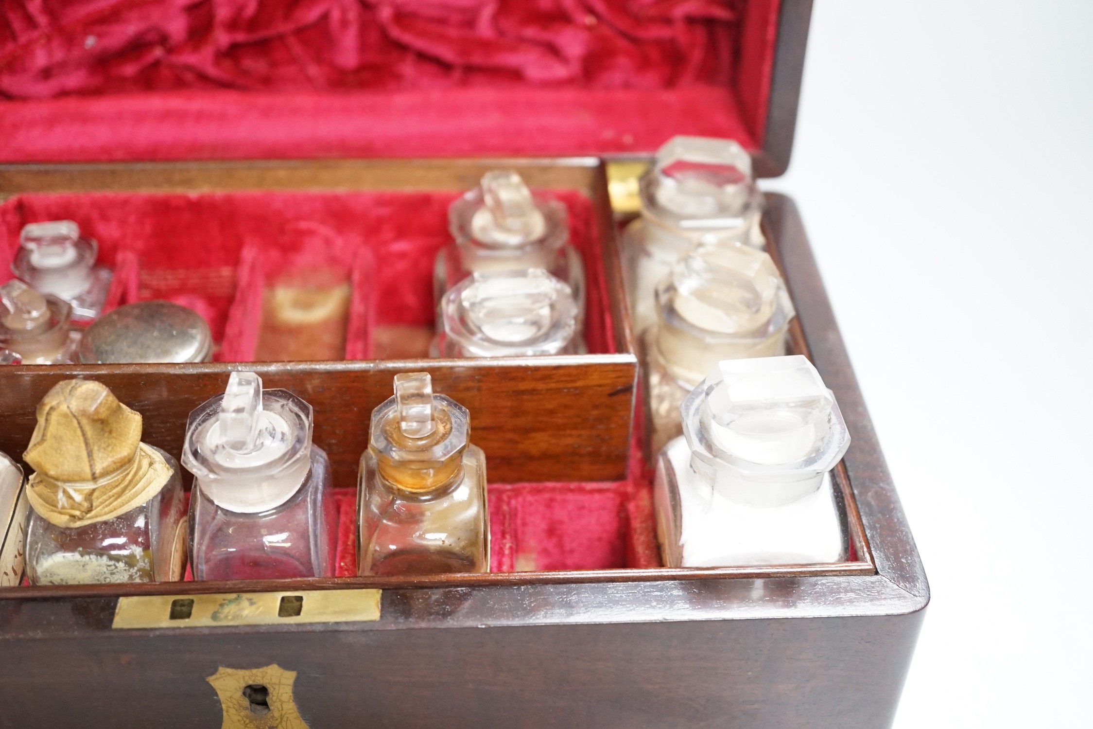 A 19th century mahogany cased travelling apothecary set with glass flasks, handle plate engraved ‘Dr.Tulk’, 26cm wide